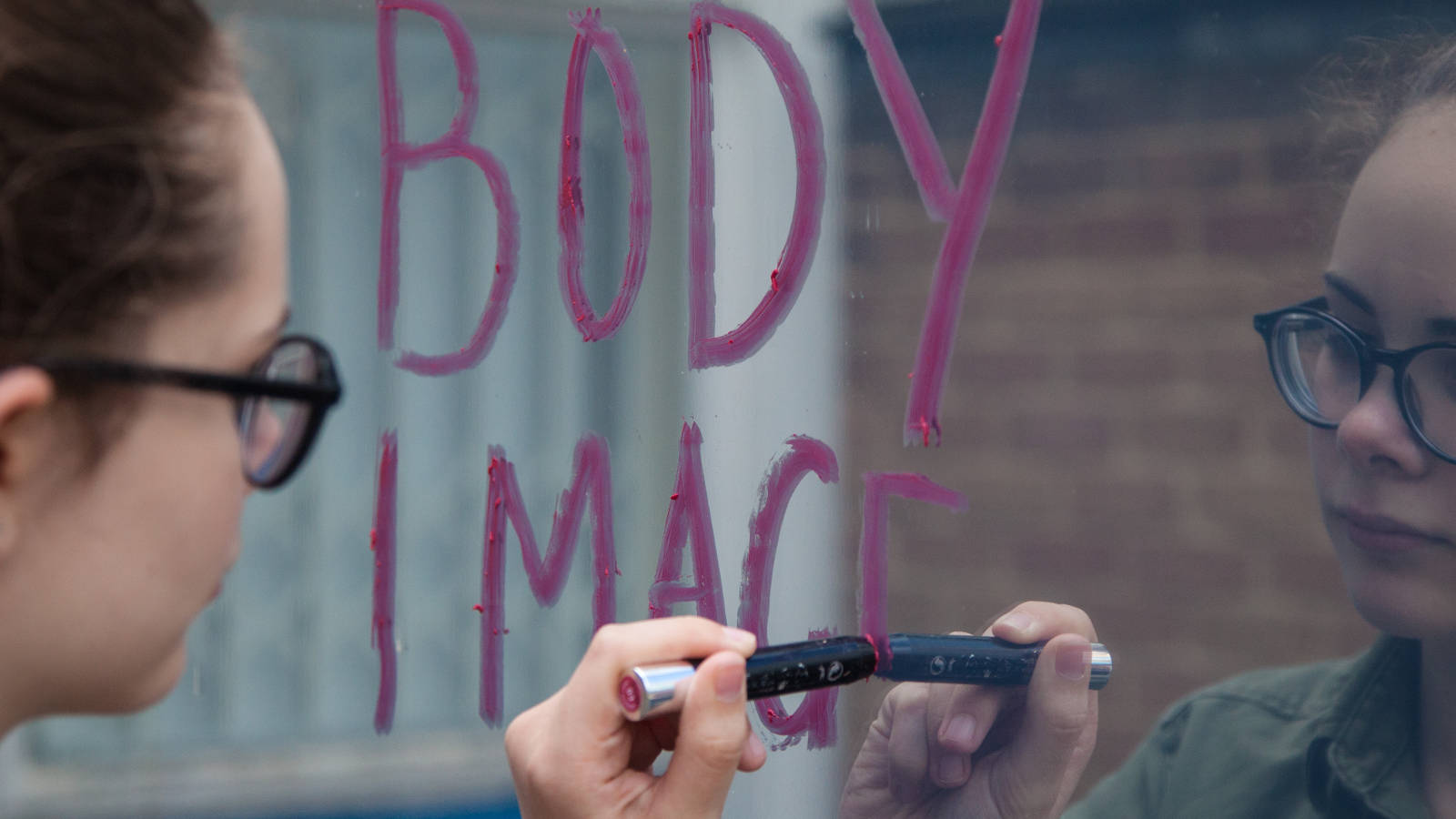 Body Image written on a mirror with lipstick