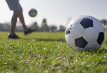 A male kicking a football