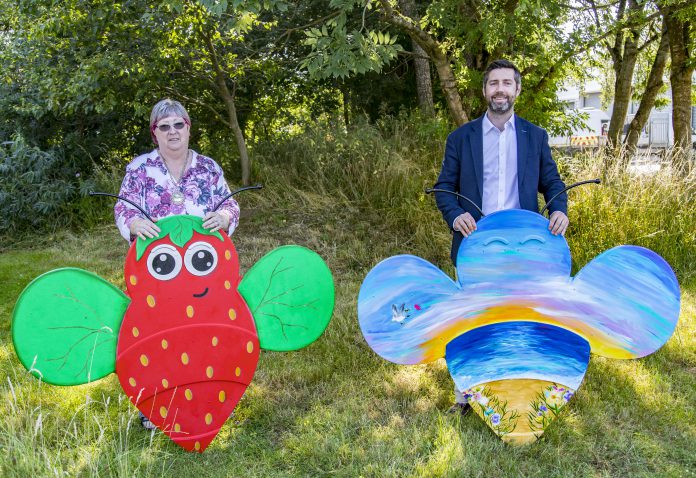 Chair of Council, Councillor Ruth Davis and Leader of the Council, Toby Savage holding two of the bee trail bees.