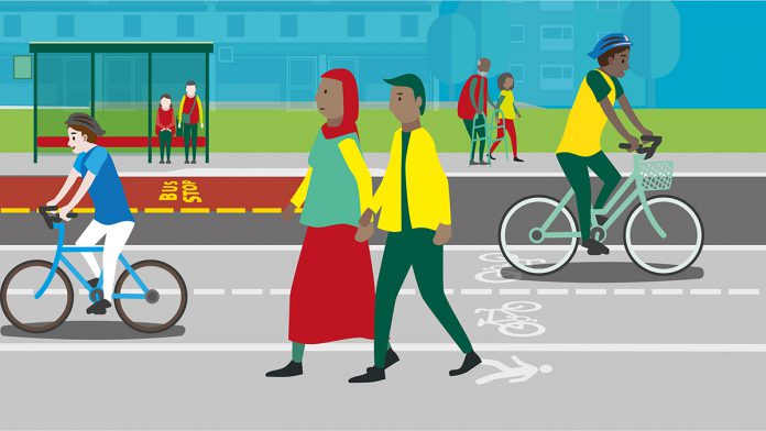 An animated image of people walking and cycling with people at a bus stop in the background