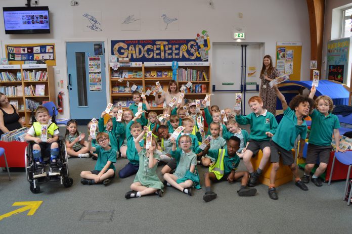 Pupils from Emerson’s Green Primary School with Children’s author Emma Perry at Emerson’s Green Library, to mark the Summer Reading Challenge.