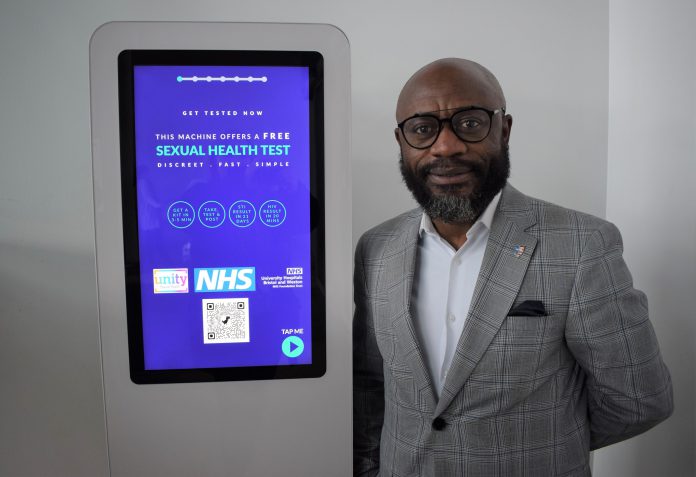 Coucillor Owusu-Antwi next to one of the vending machines