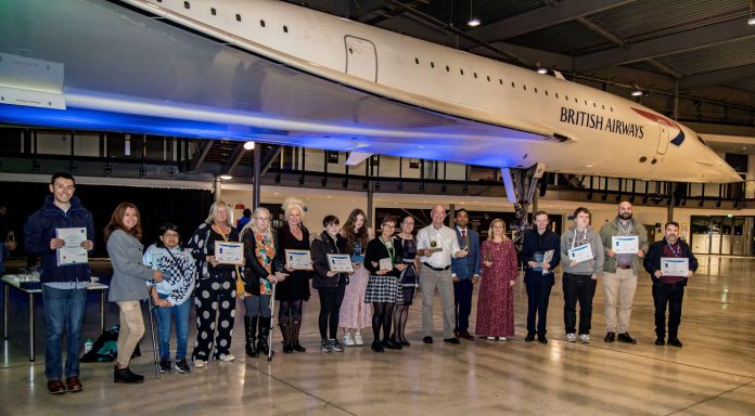 Community Learning award winners gather at an event at Bristol Aerospace Museum