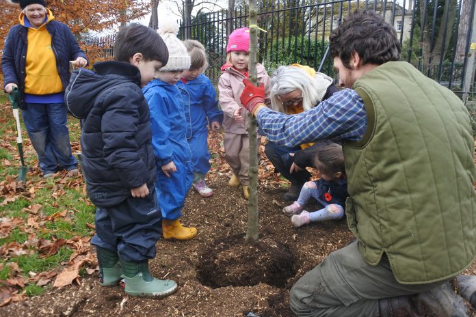 Teachers and children planting new trees