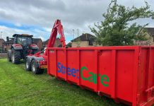 A tractor and container for grass cuttings