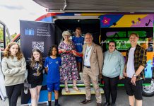 Councillor Maggie Tyrrell and Councillor Sean Rhodes cutting the ribbon to launch the bus, with members of the South Gloucestershire Youth Board and other young people who attend youth sessions at Patchway Youth Centre