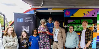 Councillor Maggie Tyrrell and Councillor Sean Rhodes cutting the ribbon to launch the bus, with members of the South Gloucestershire Youth Board and other young people who attend youth sessions at Patchway Youth Centre