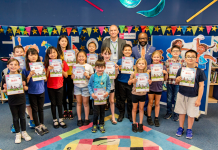 Chair of South Gloucestershire Council, councillor Franklin Owusu-Antwi, and cabinet member with responsibility for libraries, councillor Sean Rhodes, pictured at Bradley Stoke Library with children who took part in the Summer Reading Challenge 2024.