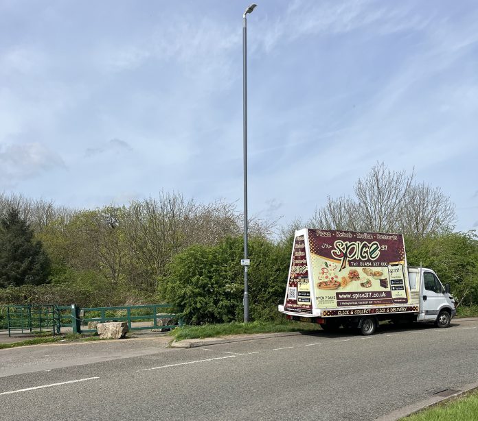 A banner van parked on the roadside