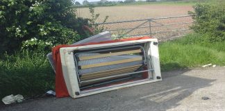 a fly-tipped sofa on the roadside