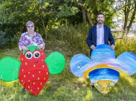 Chair of Council, Councillor Ruth Davis and Leader of the Council, Toby Savage holding two of the bee trail bees.