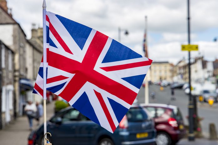 A Union Jack flag in front of a street scene