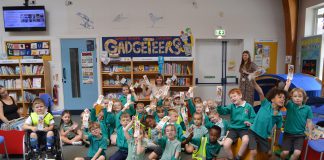 Pupils from Emerson’s Green Primary School with Children’s author Emma Perry at Emerson’s Green Library, to mark the Summer Reading Challenge.
