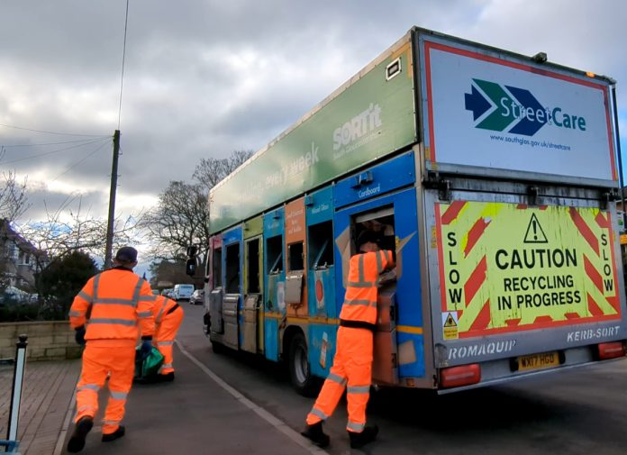 Waste operatives loading recycling on to a truck