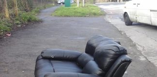 A photograph of a fly-tipped sofa