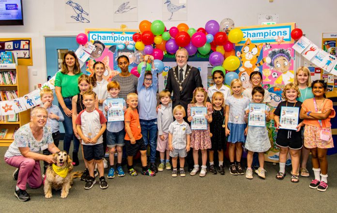 Chair of the Council, Councillor Mike Drew joins a group of children and Summer Reading Challenge volunteers at Emersons Green Library to celebrate everyone who took part in this year’s Summer Reading Challenge.