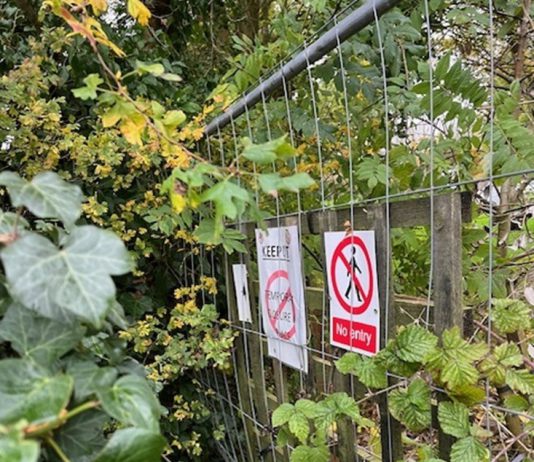 A fenced off path with no entry signs