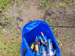 A large blue bag full of empty whipped cream cannisters