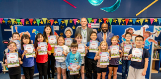 Chair of South Gloucestershire Council, councillor Franklin Owusu-Antwi, and cabinet member with responsibility for libraries, councillor Sean Rhodes, pictured at Bradley Stoke Library with children who took part in the Summer Reading Challenge 2024.