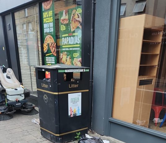 Waste spilling from a black bin bag on the pavement