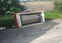 a fly-tipped sofa on the roadside