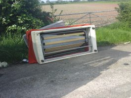 a fly-tipped sofa on the roadside