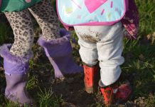 Young children standing in mud