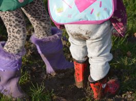 Young children standing in mud