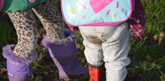 Young children standing in mud