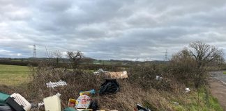Fly-tipped waste on a grass verge