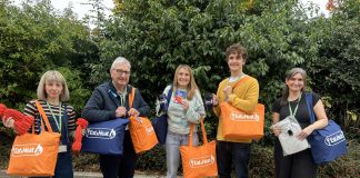 Councillor Alison Evans, cabinet member for cost of living, equalities and public health, Councillor Tony Williams, lead partner member for cost of living, equalities and public health, and some of the staff that helped put together the warm packs