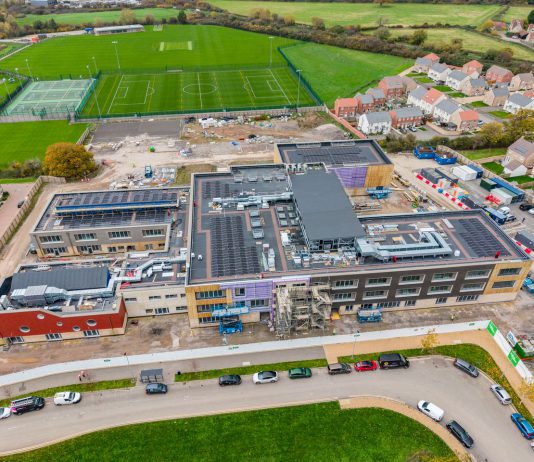 The attached image shows an aerial view of the schools, with the exterior construction now complete.