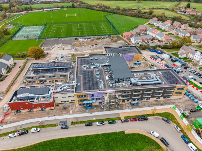 The attached image shows an aerial view of the schools, with the exterior construction now complete.