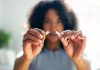 Woman breaking down cigarette to pieces.