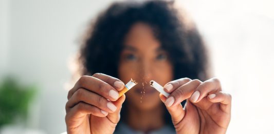 South West Directors of Public Health welcome Tobacco and Vapes Act becoming law – and urge the 520,000 people who smoke to take the moment to quit Woman breaking down cigarette to pieces.