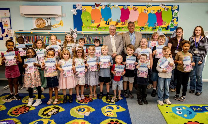 Chair of South Gloucestershire Council, councillor Adrian Rush (Back row, centre left) and Cabinet Member with responsibility for Libraries, councillor John Bradbury (Back row, centre right), are pictured with local children who participated in the Challenge, along with volunteers, at Hanham Library.