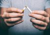 male hand snapping cigarette