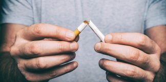male hand snapping cigarette