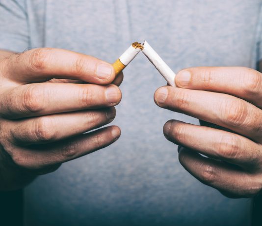 male hand snapping cigarette