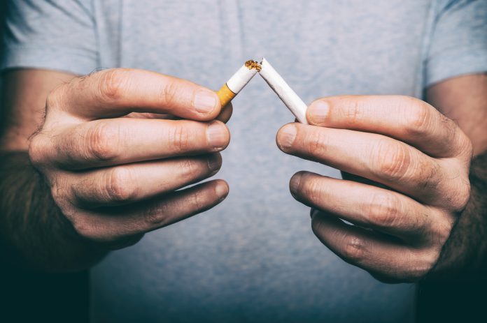male hand snapping cigarette
