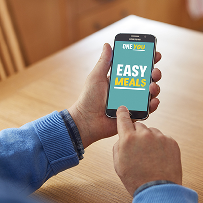 A person looking at the "One You Easy Meals" app on their mobile phone.