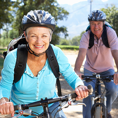 Senior couple on country bike ride smiling to camera